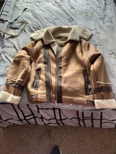 River island unisex fur lined winter jacket faux leather outer material.