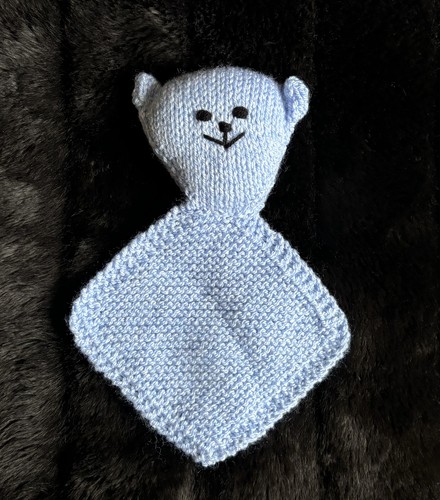 Small hand knitted teddy bear - hand,