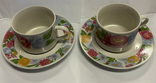 Two cups and saucers with - and,