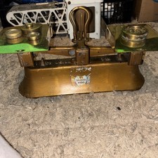 set of vintage or antique brass postal scales with weights.