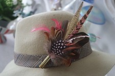 feather and bullet brooch, hat