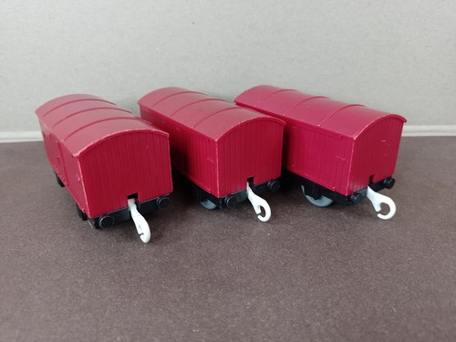 Three red vans wagons - three,