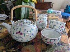 Oriental ceramic teapot and 6 tea bowls.  Floral pattern. Perfect condition.