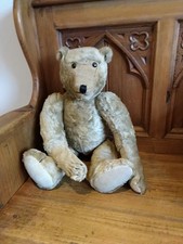 A Harrods mohair teddy bear with boot button eyes, stitched snout and claws