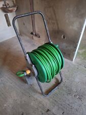 Fifty metres green garden hose in a cart