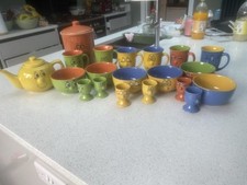 Trade Winds Tableware Funny Faces Mugs Orange And Yellow