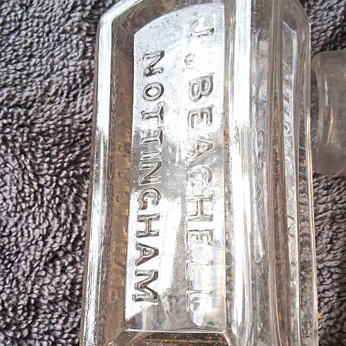 Antique embossed glass chemist - embossed,