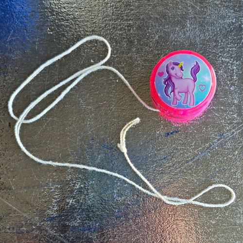 Pink plastic with string - yo-yo,