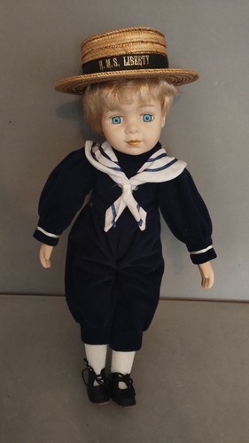 Porcelain doll dressed his - in,