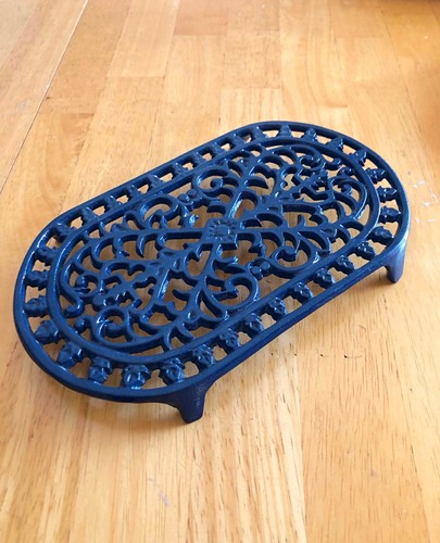 Ornate cast iron trivet oval - cast,