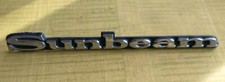 SUNBEAM LOTUS BADGE EMBLEM SCRIPT NOS CHROME FACIA & BLACK BACKGROUND