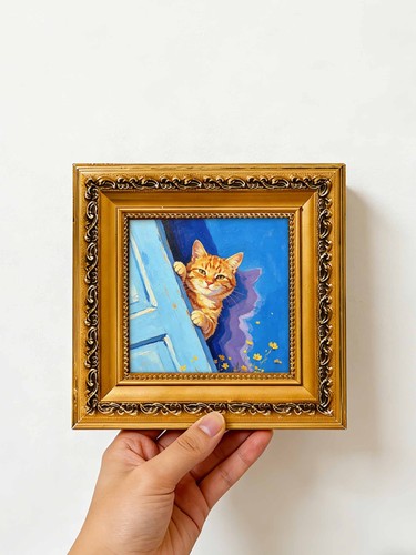 Orange cat peeking behind blue - cat,