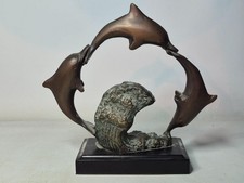 Three Bronze Dolphins Jumping