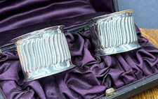 A pair of fluted silver napkin rings in fitted case Birm 1890