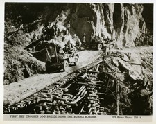 US Army jeeps crossing a log
