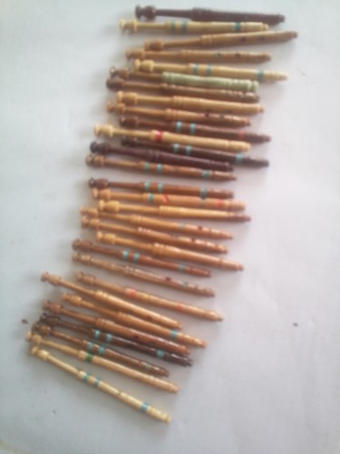 Thirty wooden travel bobbins