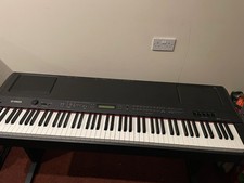 Yamaha P-250 Digital Stage/Home Piano with a wooden stand