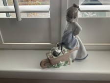 NAO Girl With Puppy In Wheelbarrow