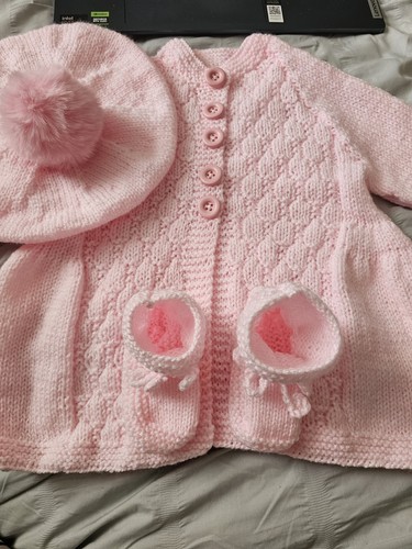 Hand knitted pink layette - hand,