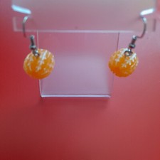 1 pair very small orange peel shape ladies earrings.