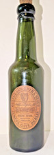 ENNISKILLEN, JOSEPH REGAN. RARE LABELLED GUINNESS BOTTLE. 1940.   9 inches tall.