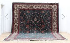 K ashan carpet  foliate and floral motifs to a dark green ground 302 x 385cm
