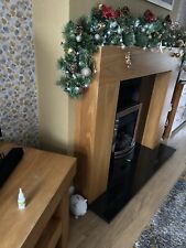   black granite surround and plinth with modern oak mantle