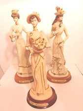 VINTAGE REGENCY LADY FIGURINES SET OF THREE BY MICHELANGELO ON WOODEN STANDS 