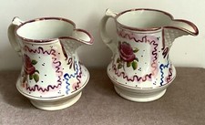 Pair of Victorian pink lustre jugs