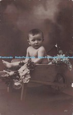 R692967 Little Child sits in a Little Wheelbarrow. Woolstone Bros. Hand Coloured