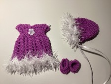Hand knitted dolls clothes to