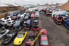Photo 12x8 Scrap Yard by the railway Grimsby Looking down onto a vehicle s c2016