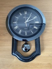 Quartz Timemaster Wall Clock with Pendulum and Roman Numerals In Black Plastic