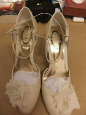 Ivory satin shoes by Debut with ankle strap and flower/pearl detail.S7.Heel 4".