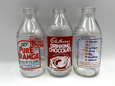 Three vintage milk bottles, 18cm high, in excellent condition.