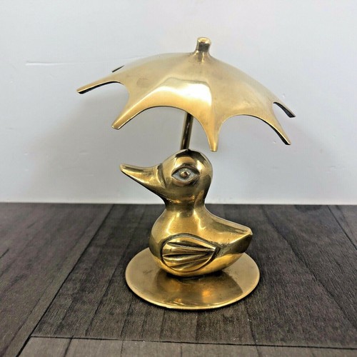 Brass duck sitting - duck, under