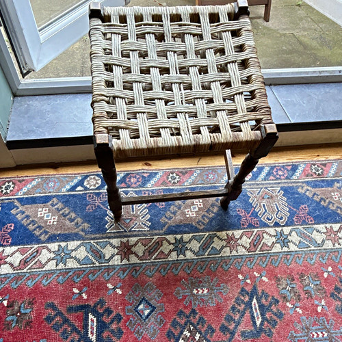 Dark wood stool with - dark, woven
