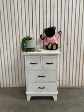 White 4-drawer bedside cabinets with 2 small and 2 large drawers.