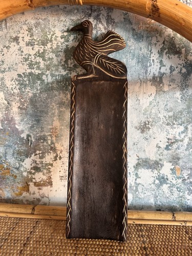 Hand carved dark wooden bird - hand,