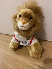 Stuffed Golden Lion Plushy Toy  with fluffy mane, wearing white shirt.