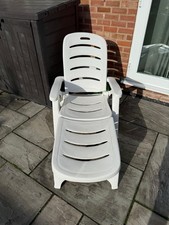 Two White Plastic Sun Loungers With Navy Blue And White Stripe Cushions Included