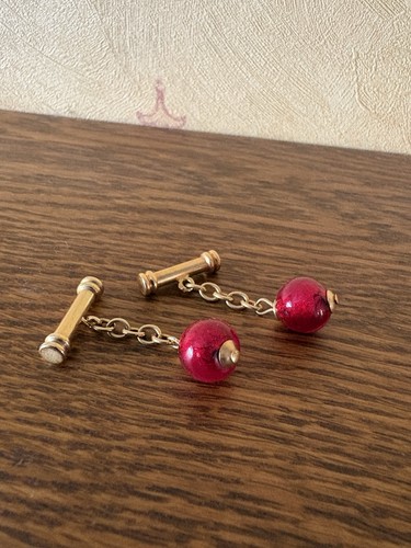 Gold tone cufflinks with red - tone,