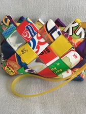 Colourful purse with wrist strap made from candy wrappers