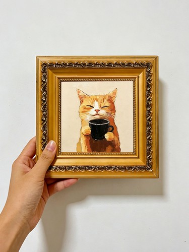 Orange cat holding black - cat,
