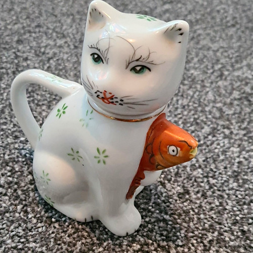 Ceramic cat figurine holding - cat,
