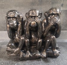 Three Wise Monkeys Sitting On