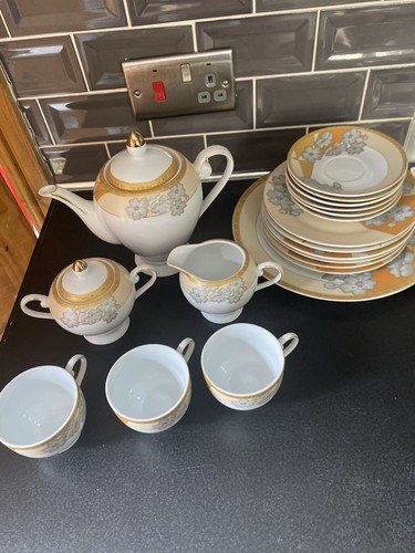 White and gold teapot - and,