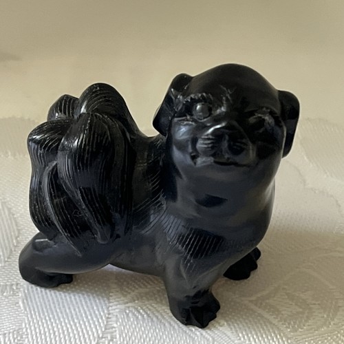 Pekingese dog carved - in, a