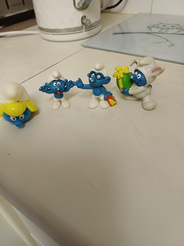 Four smurf figures - four,