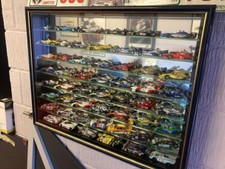 Minichamps  1:43 model car collection in cabinet. 